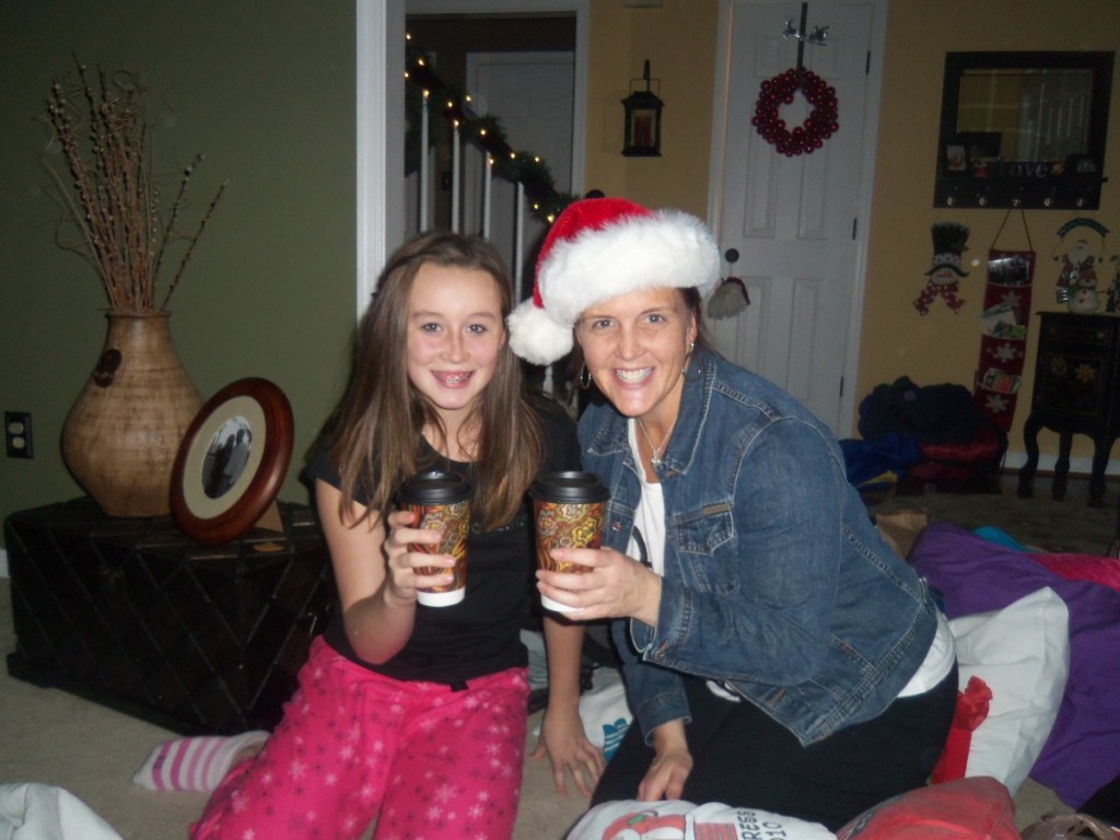 girl and woman in santa hat holding hot cocoa