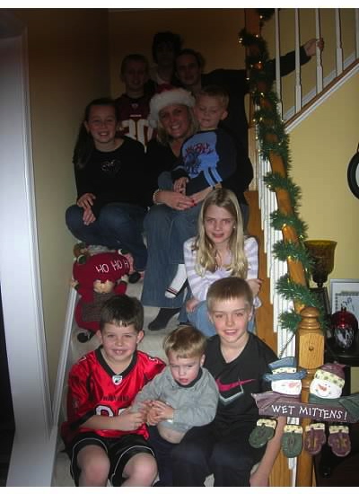 family sitting on steps in home