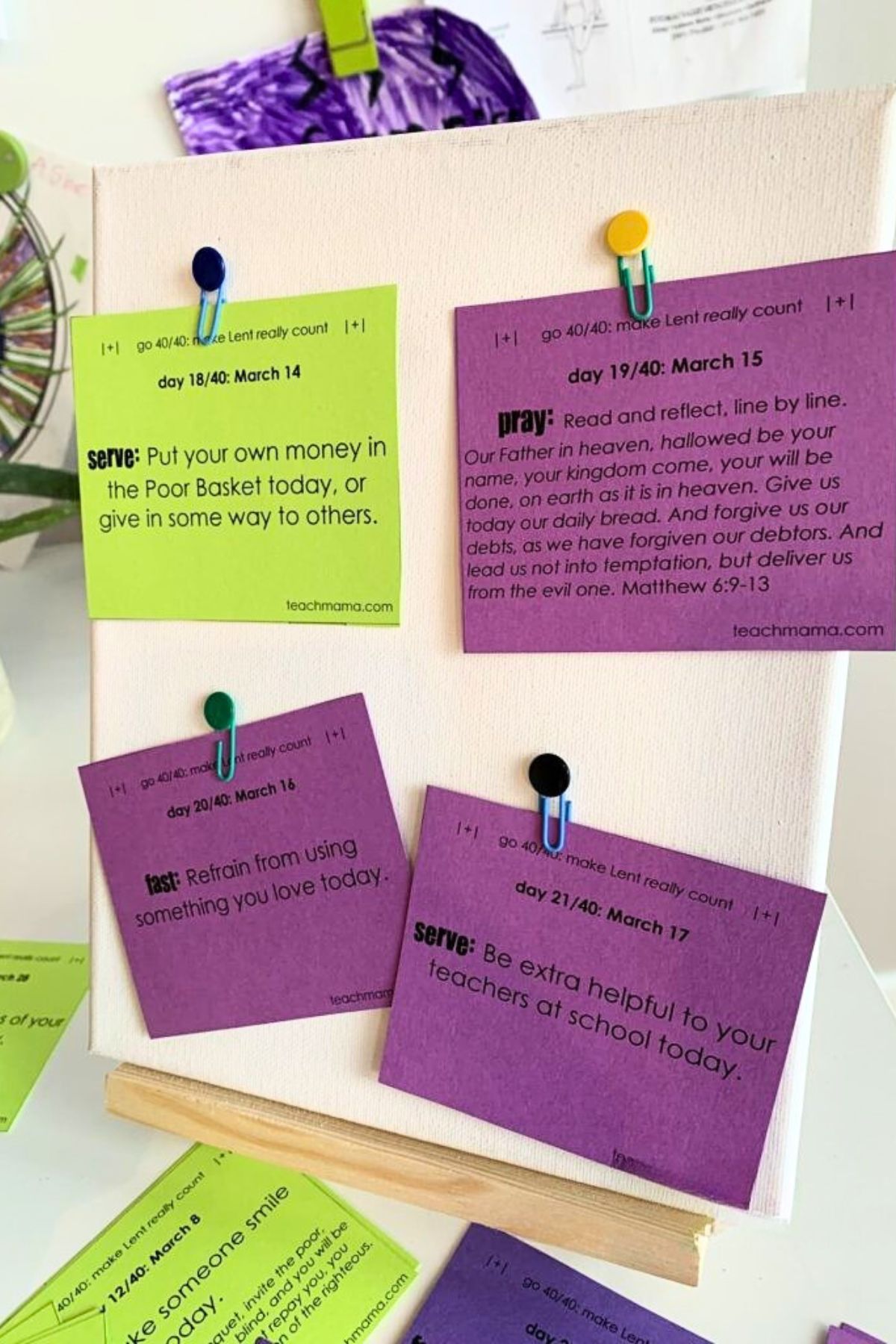 Lent cards for christian families printed in various colors and cut out for use, pinned to a small canvas 4 at a time