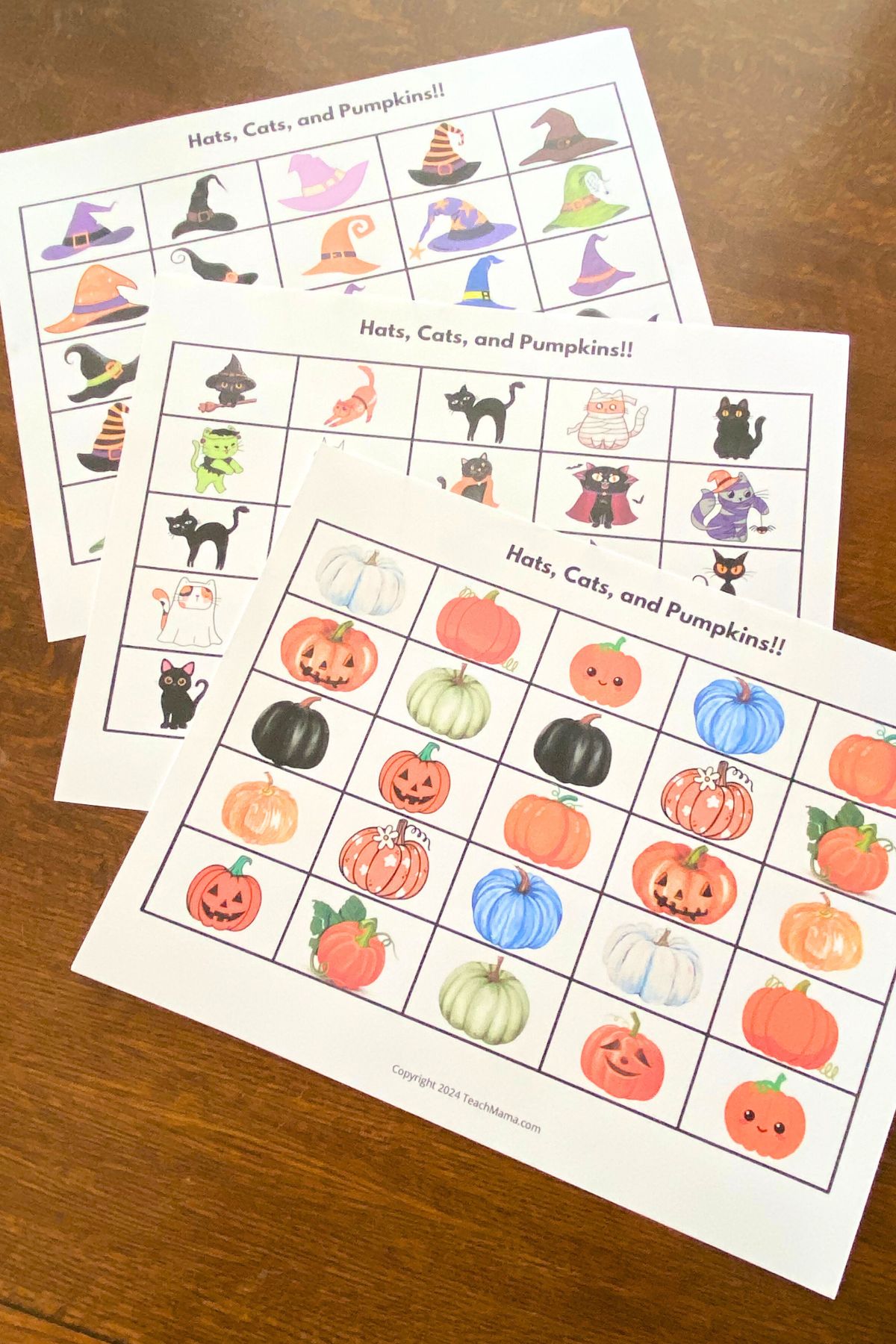 Printable grid game boards with colorful cartoon witches' hats, cats and pumpkins