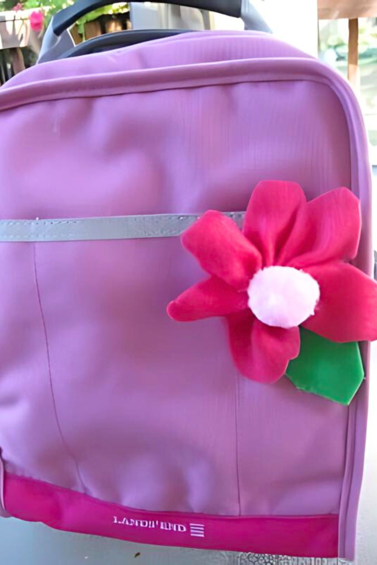 Lilac backpack with red cloth flower