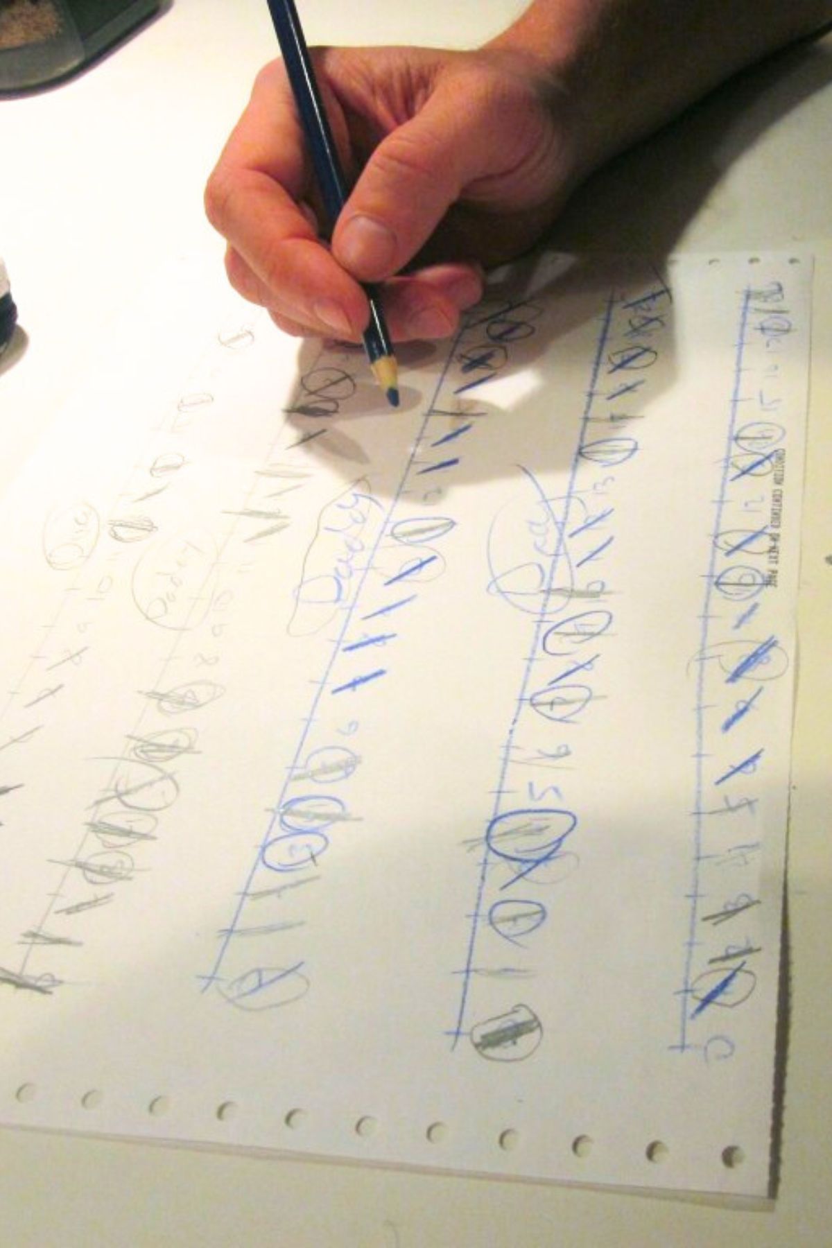 Strike-It-Out-Game-Sheet-With-Hand Holding-a-Pencil