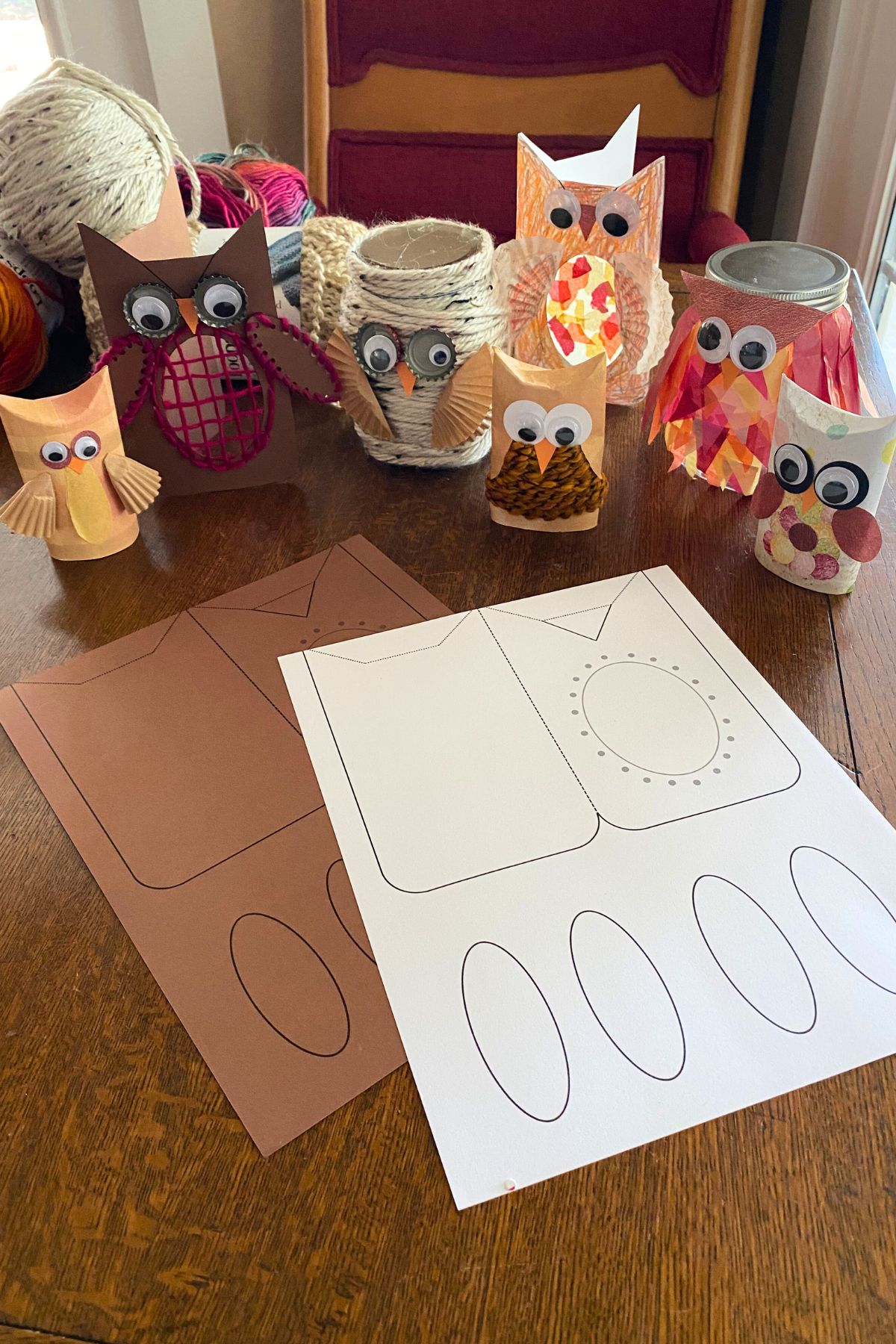 DIY owl crafts with owls made from paper rolls, jars and a printable card owl with the printable sitting on a wooden table