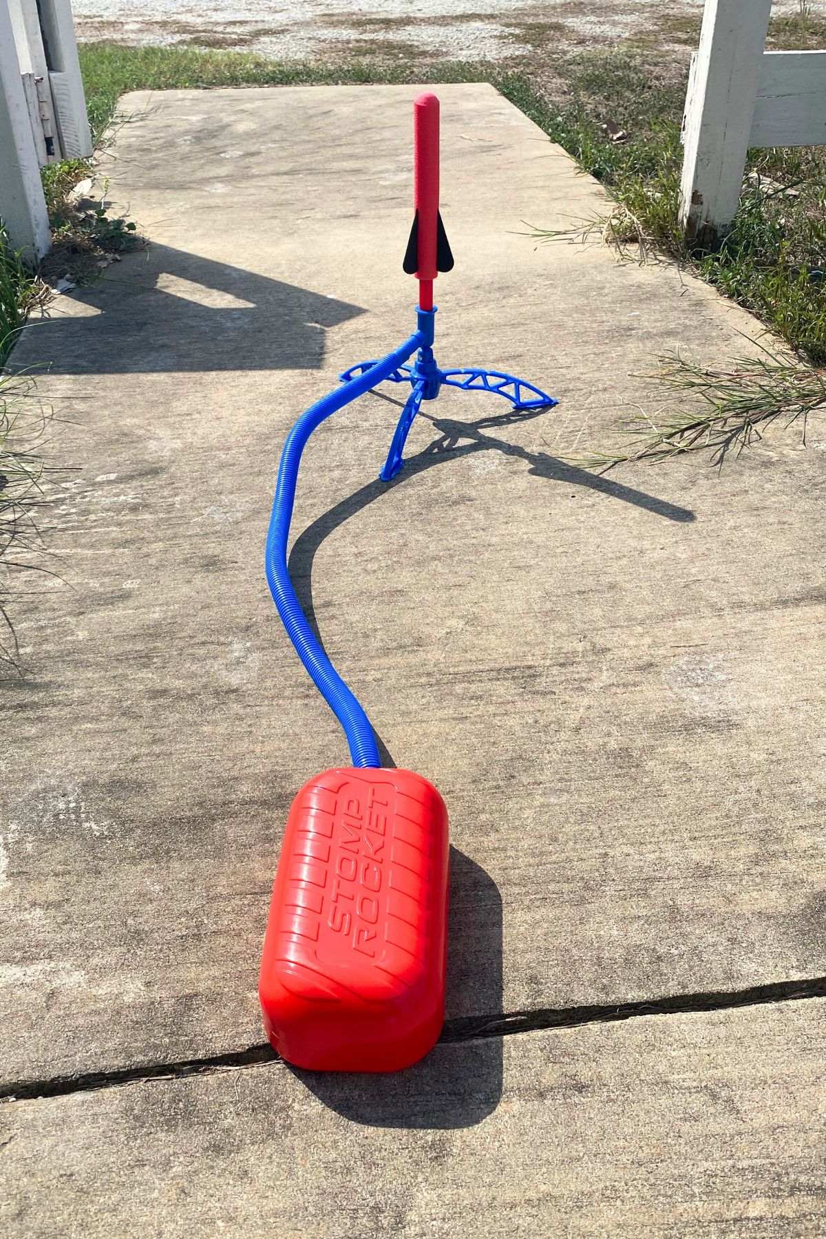 Red foam rocket on a blue stand and air hose and yellow air stomp pad