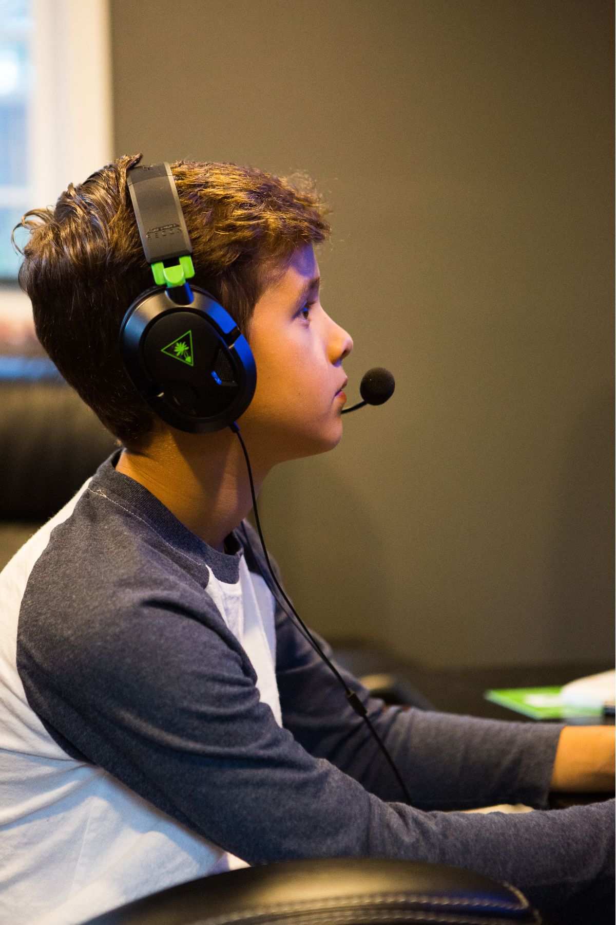 Boy with headphones focused intently