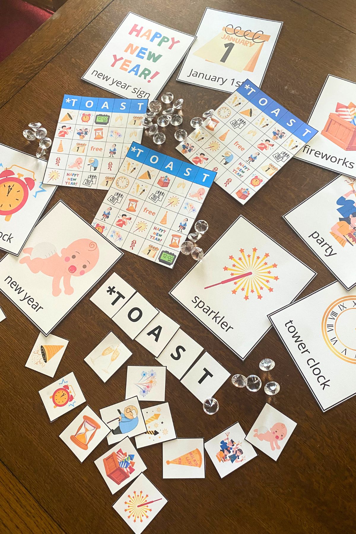 New Year themed printable Bingo boards and cards on a wooden table