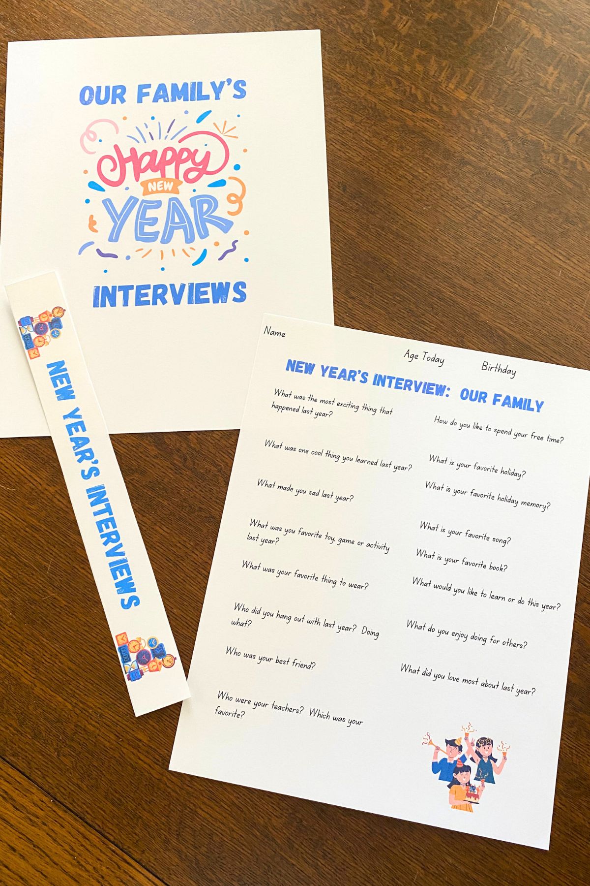 Printed family interview form, binder cover sheet and spine on a wooden table