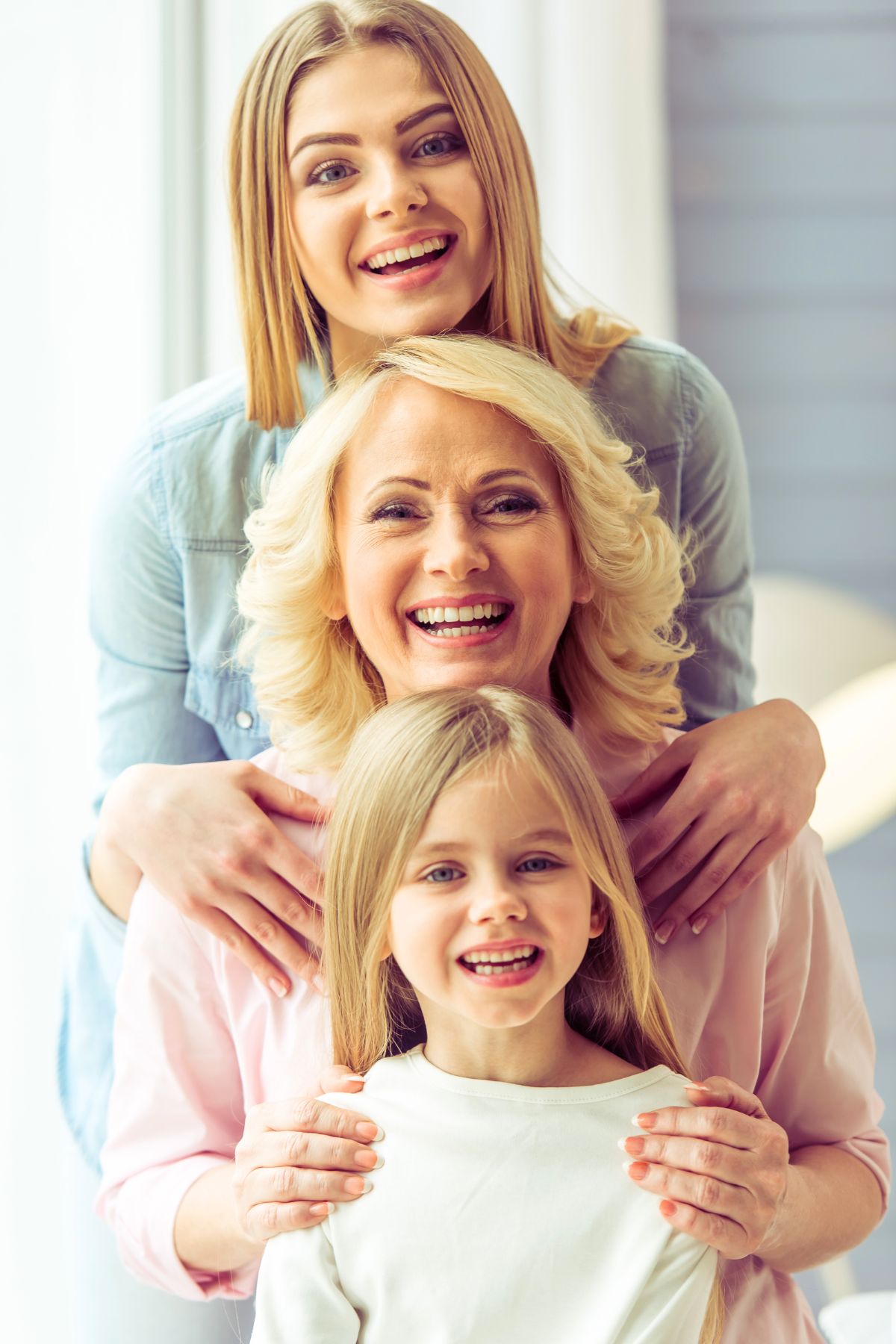 Mother, daughter and granddaughter standing in a single file