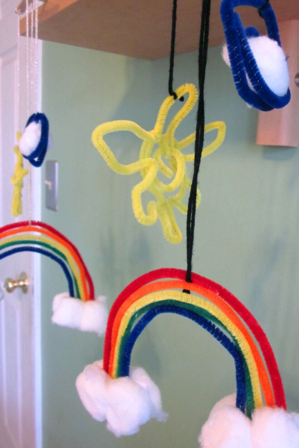 Rainbow mobile made with cotton ball clouds and colored pipe cleaners