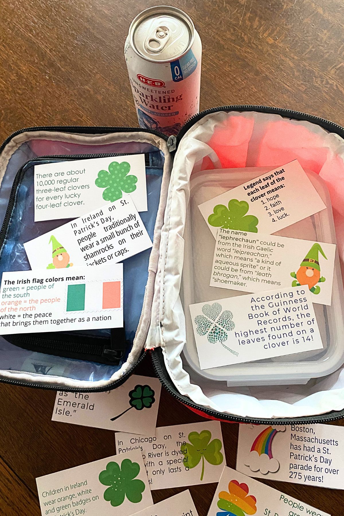Cut-out fun fact notes with a red lunch pail and canned drink on a wooden table