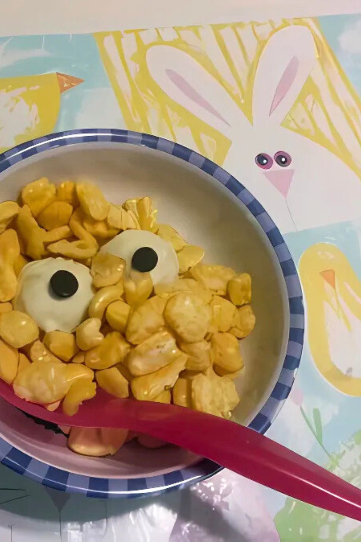 A bowl of cereal with fake eyes set in the cereal.