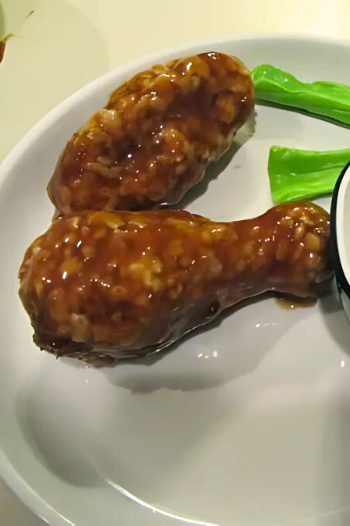 Fake Chicken wings and celery on a white plate