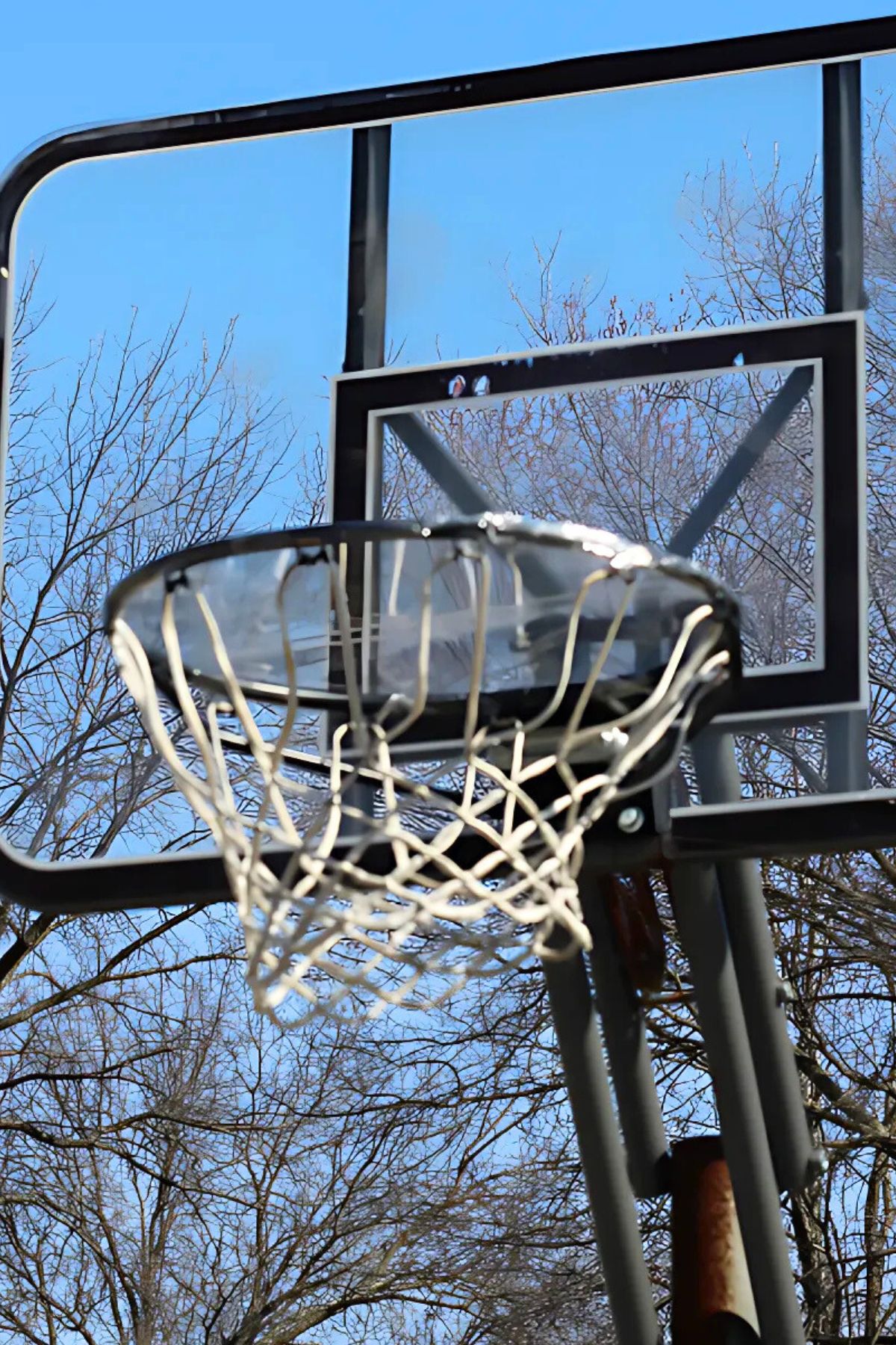 Basketball hoop with a sheet of clear plastic wrap blocking the hoop
