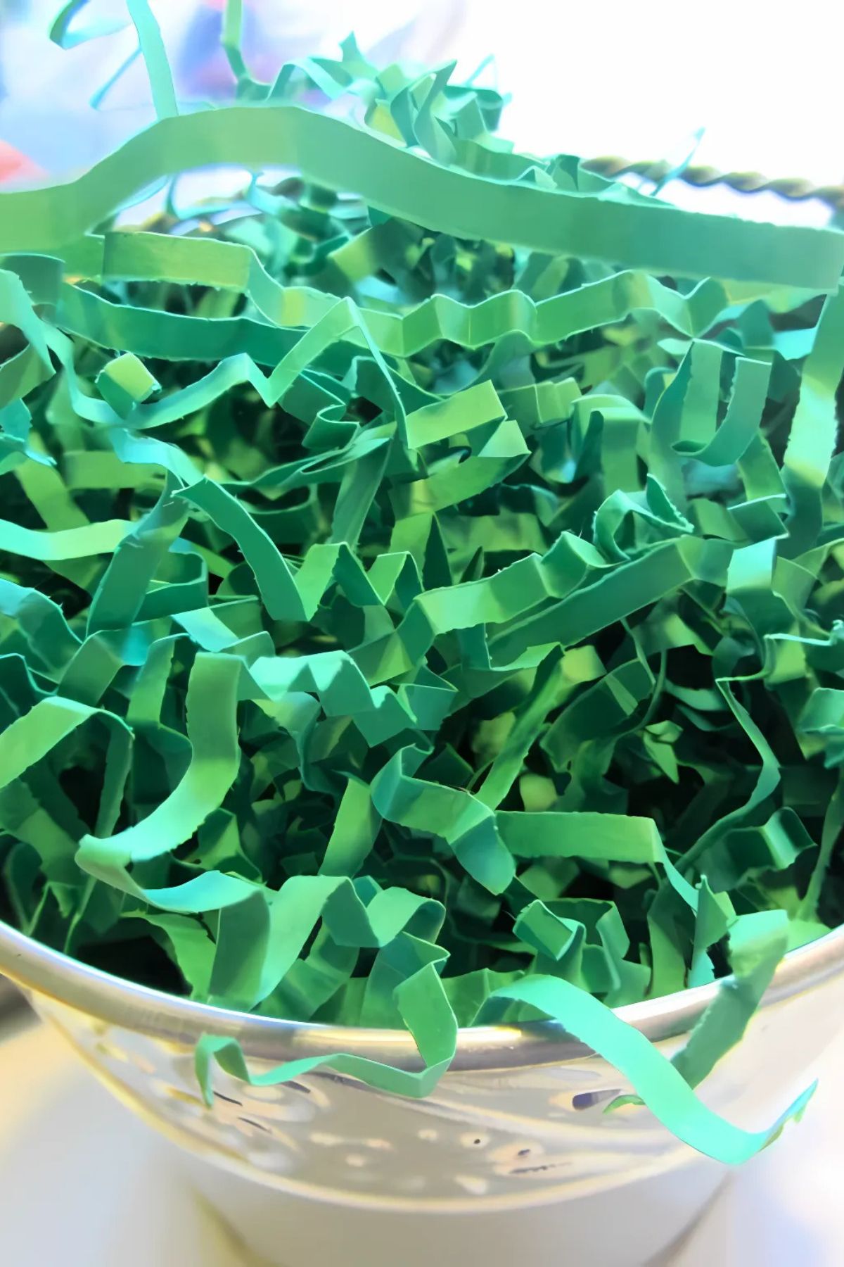 Green crinkle-paper grass in a silver bucket