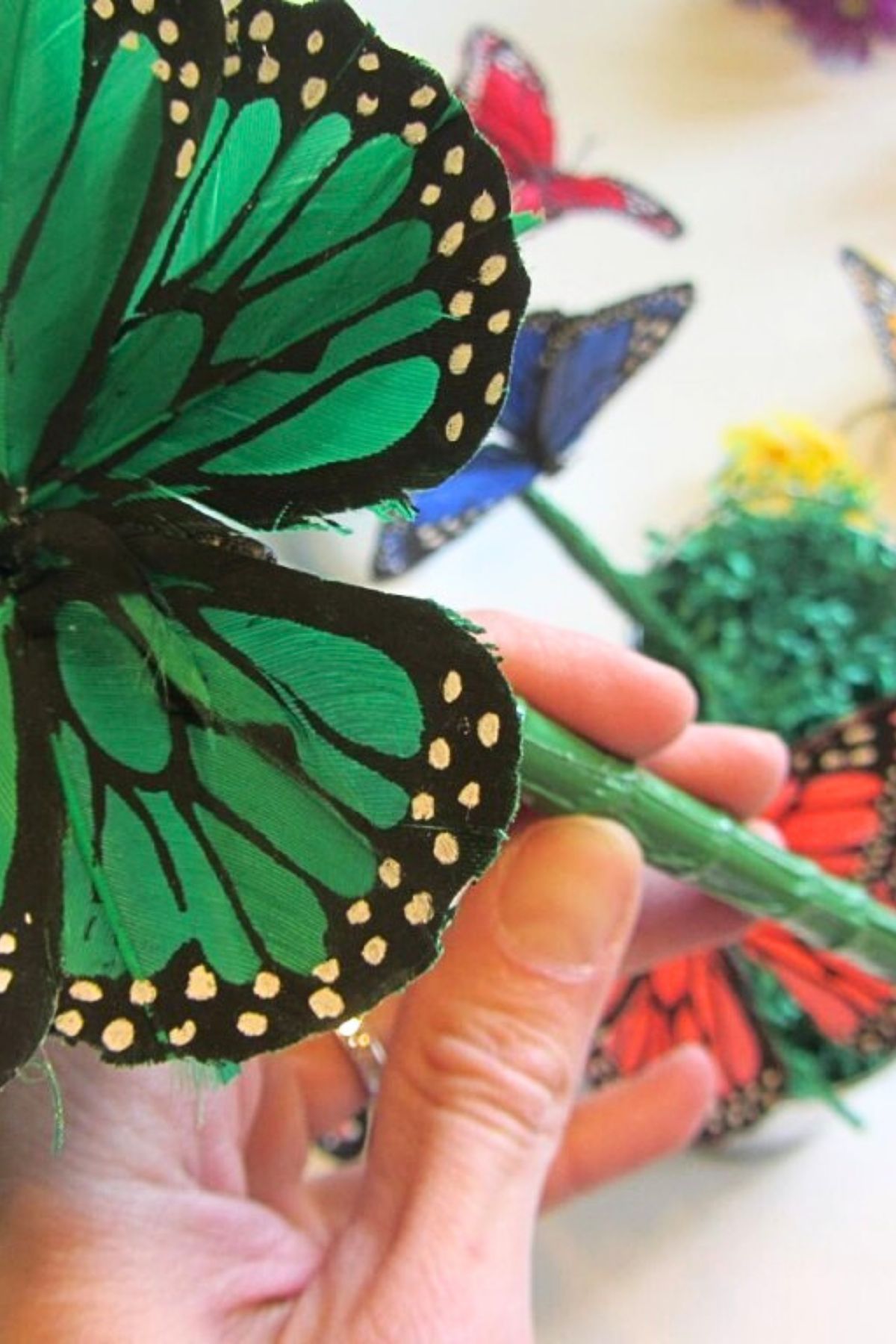 Green silk butterfly on a pen wrapped with green duct tape