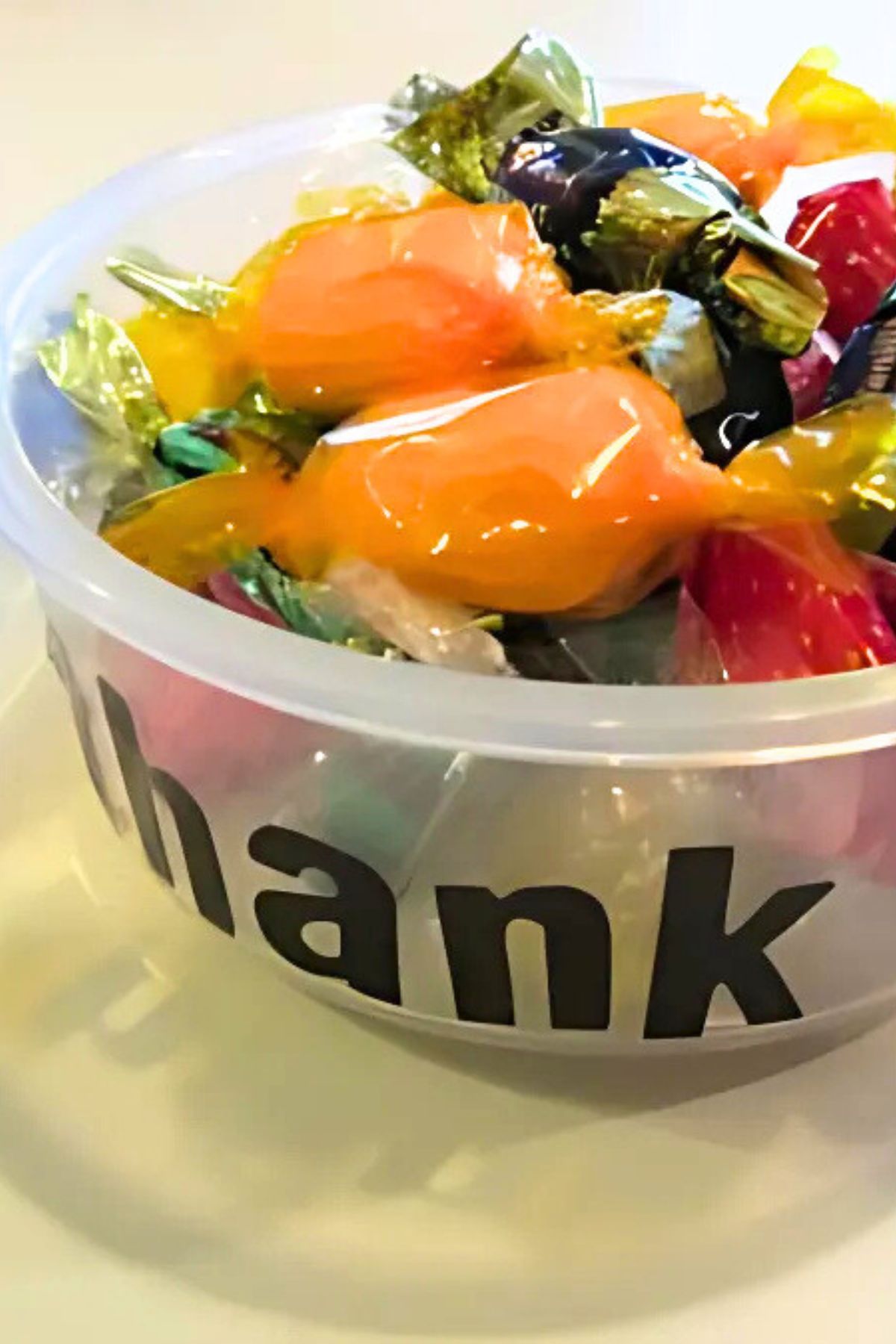 Plastic container filled with wrapped candy