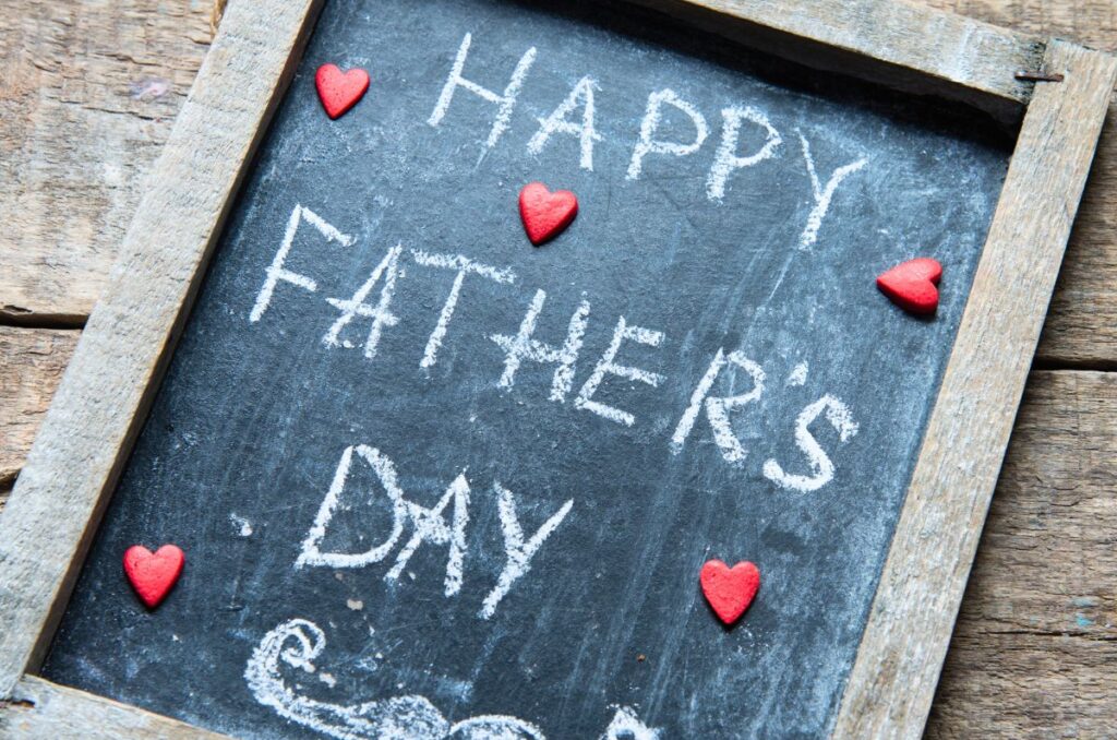 Happy Father's Day written in chalk on a small chalkboard with a wooden frame