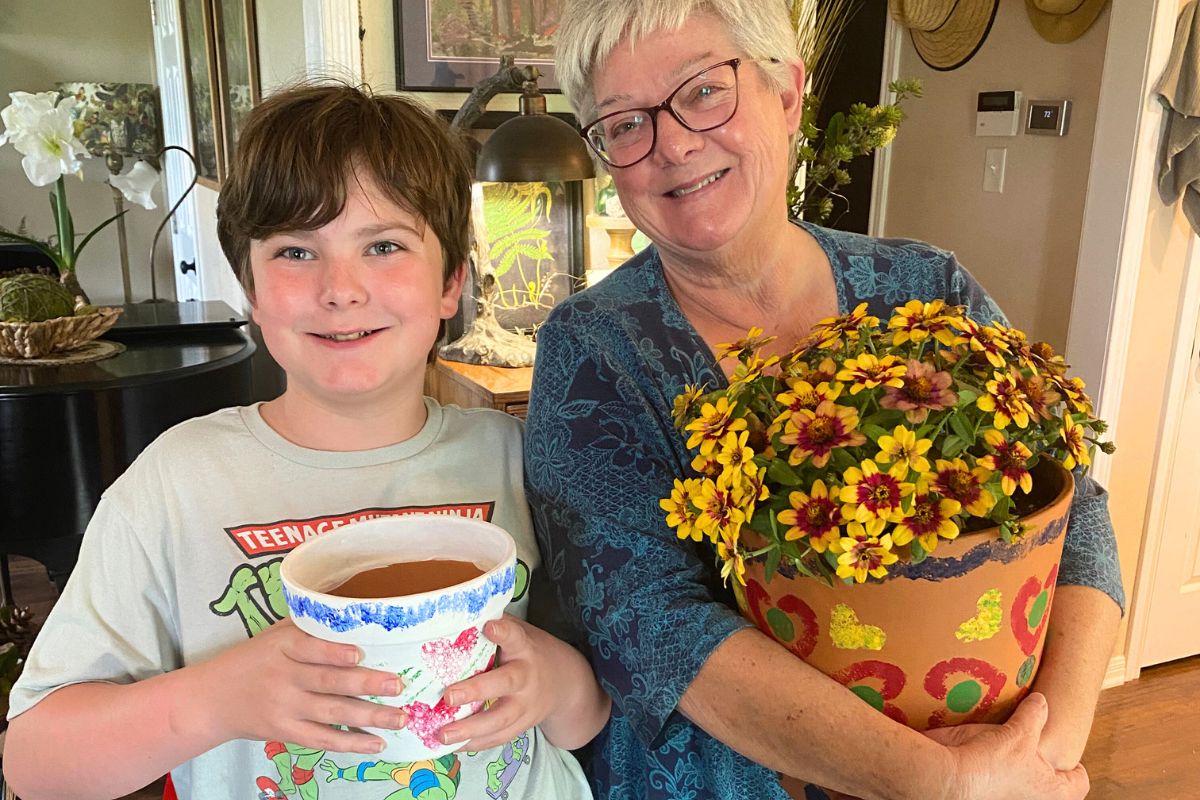 Happy grandma and grandson with the painted flower pot gifts