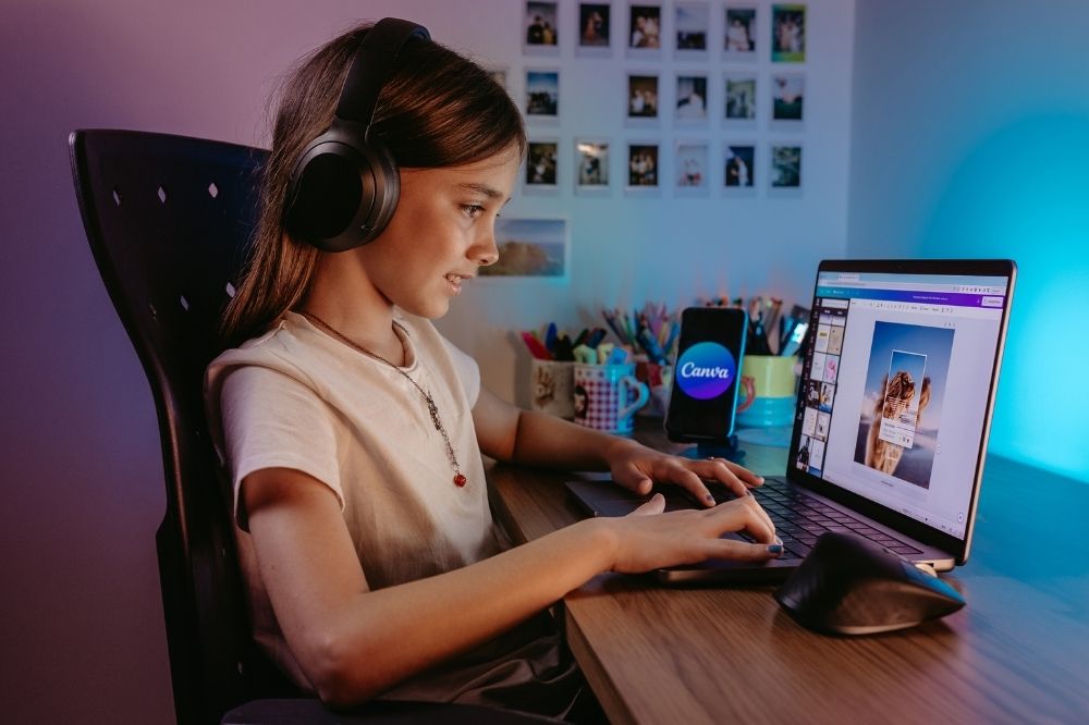 A kid enjoying editing on Canva for her assignment