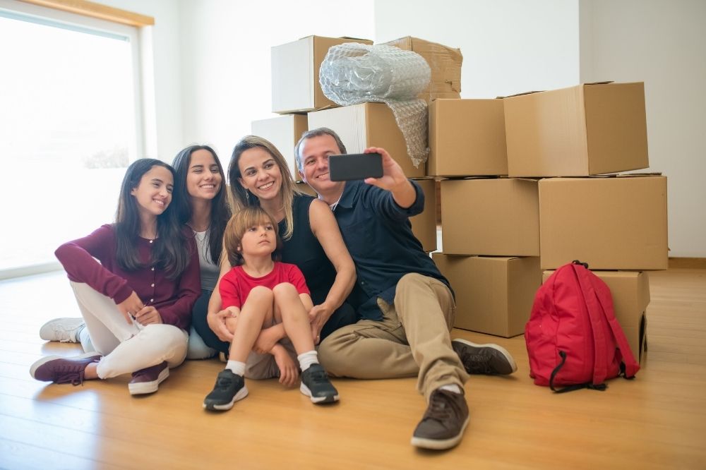 Family preparing for moving out and taking a groupie picture