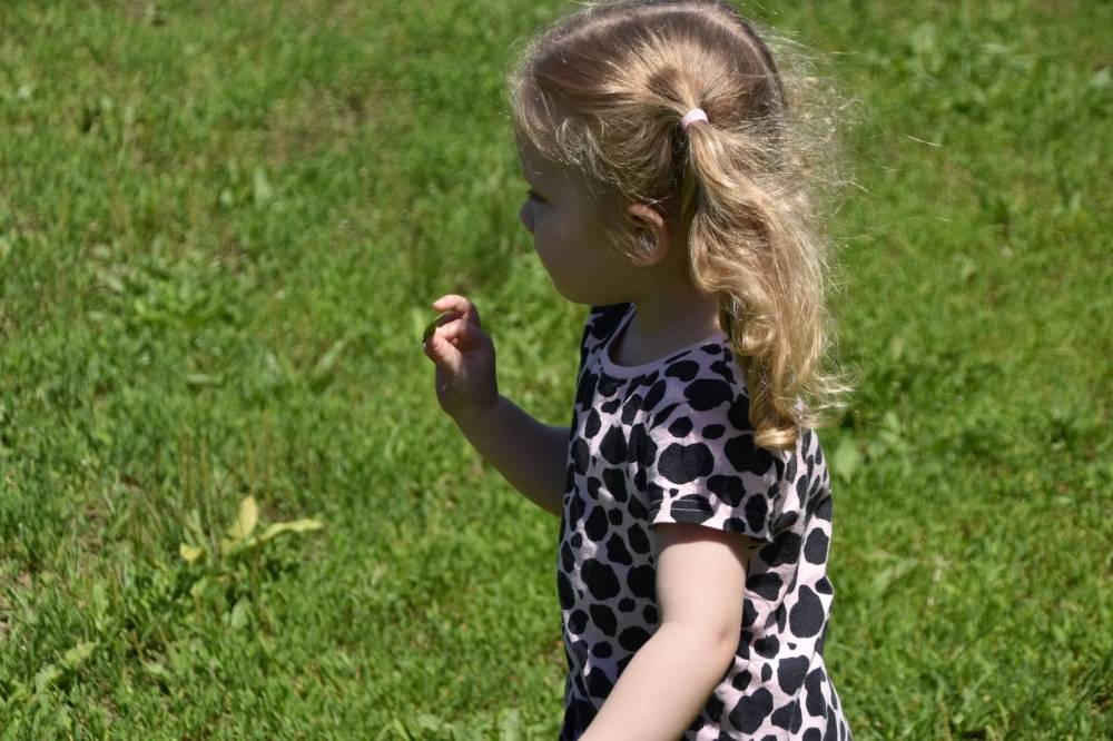 Little girl walking in the grass