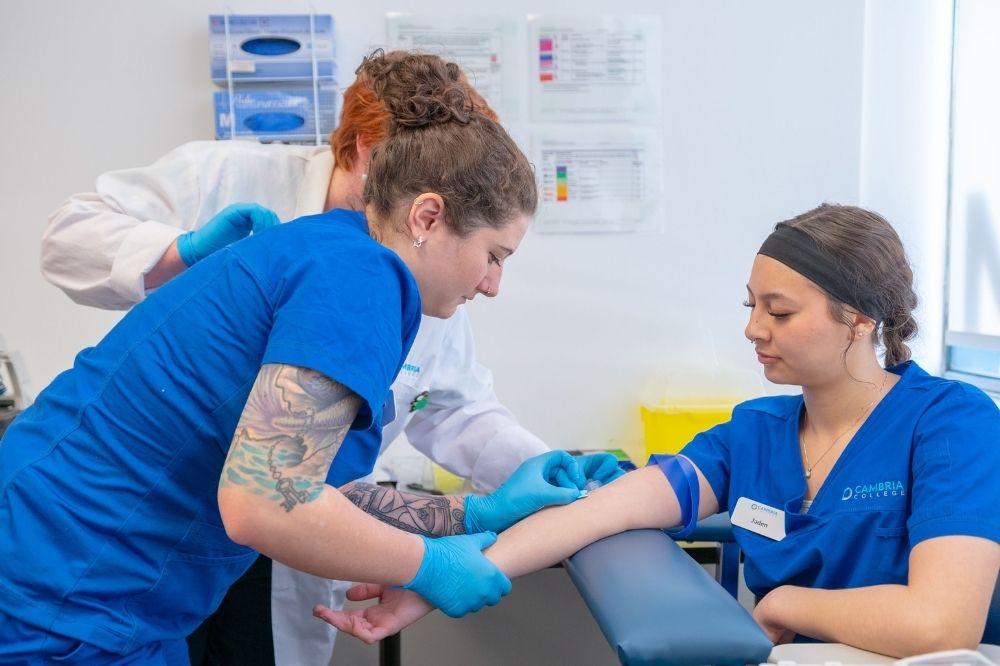 Students practicing how to draw blood
