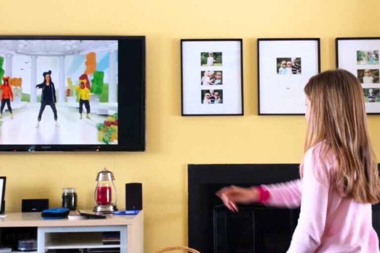 Girl dancing in front of a television to a children's dance video