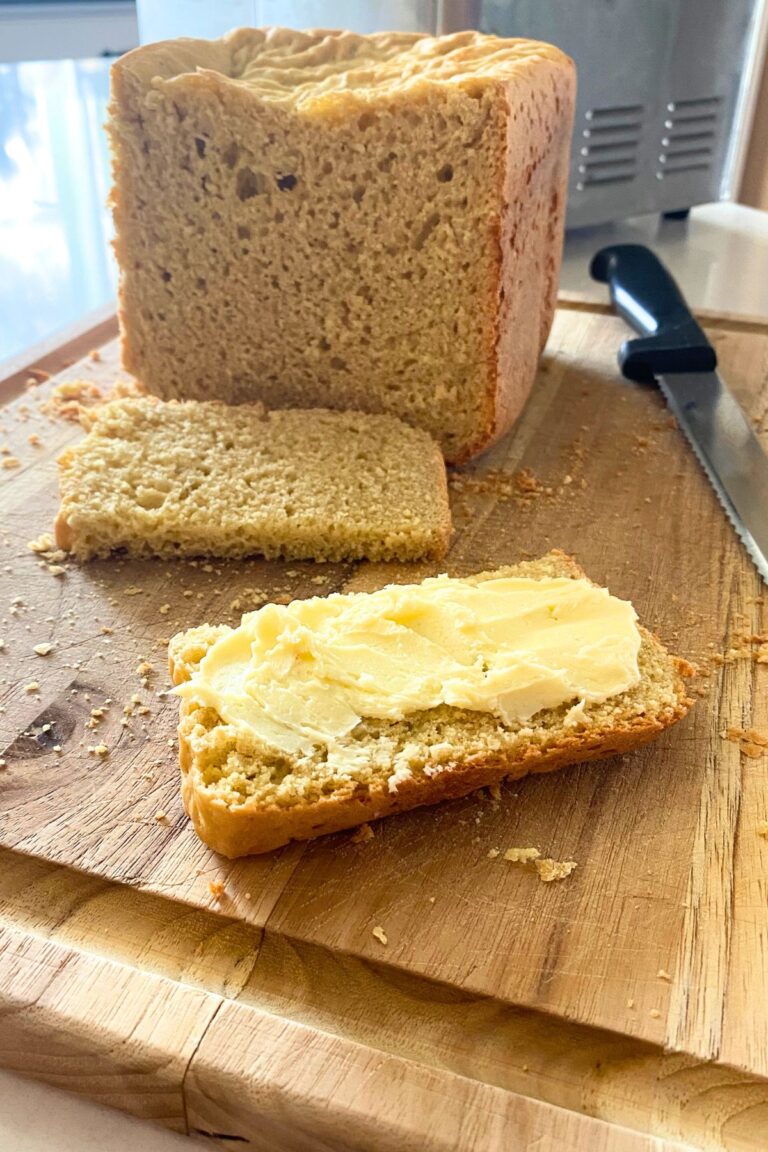 Homemade bread with butter on a wooden cutting baord