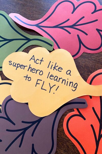 Yellow leaf printed on cardstock. Handwritten on the leaf is the instruction to act like a superhero learning to fly
