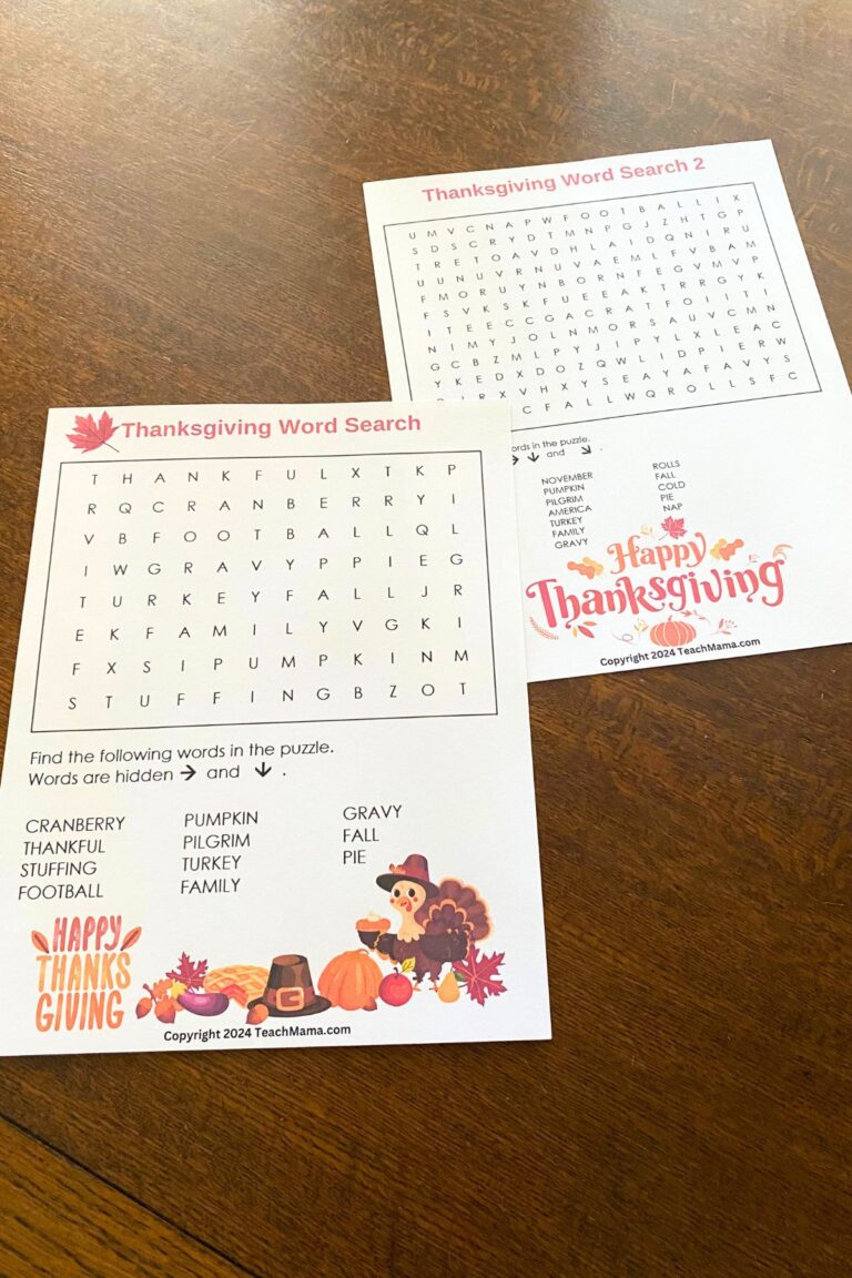 Two Thanksgiving-themed word search puzzles with colorful Thanksgiving images sitting on a wooden table