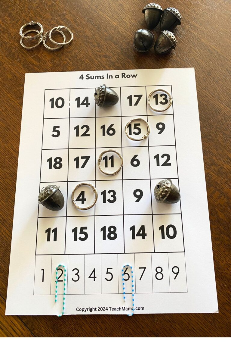 White cardstock with five columns of numbers with jump rings and metal acorns for markers