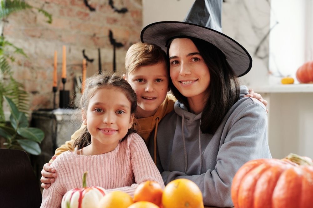 Mother and children celebrating Halloween indoors