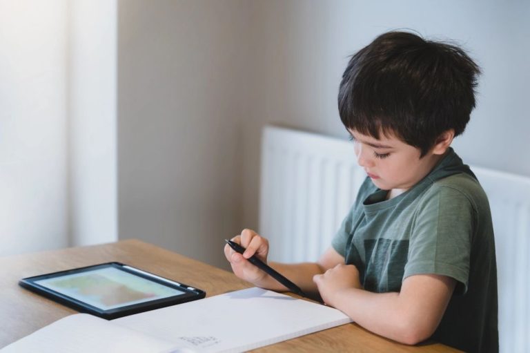 A kid studying History using his tablet