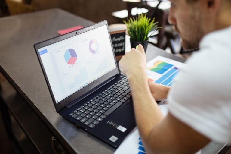 An adult man using his laptop and viewing data