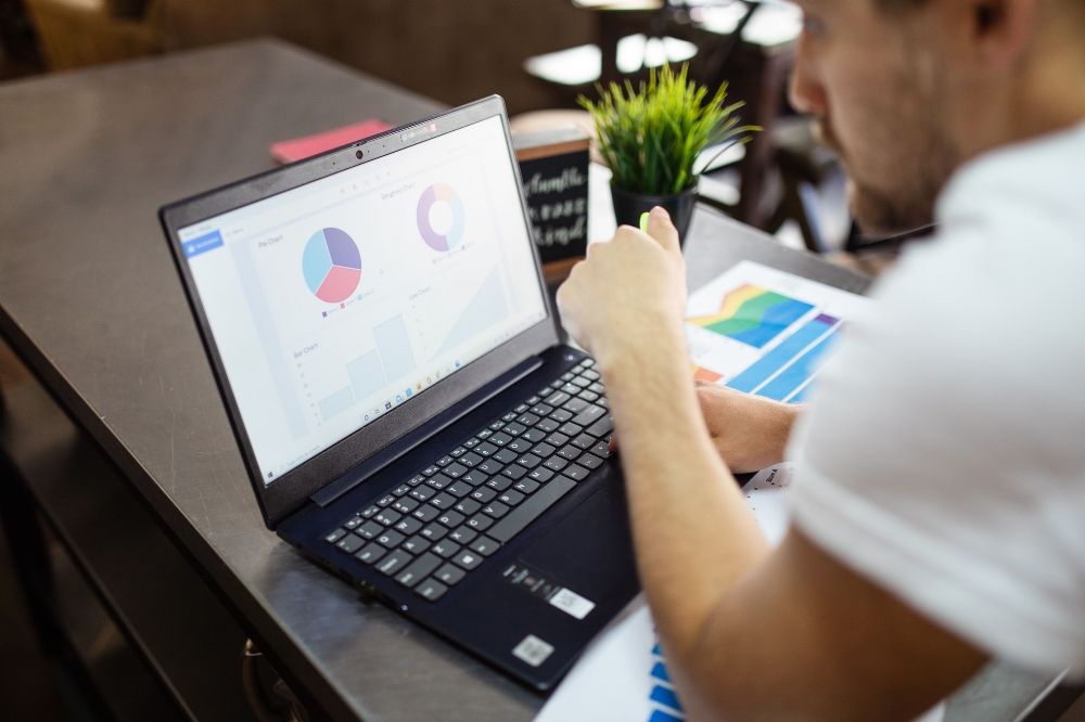 An adult man using his laptop and viewing data