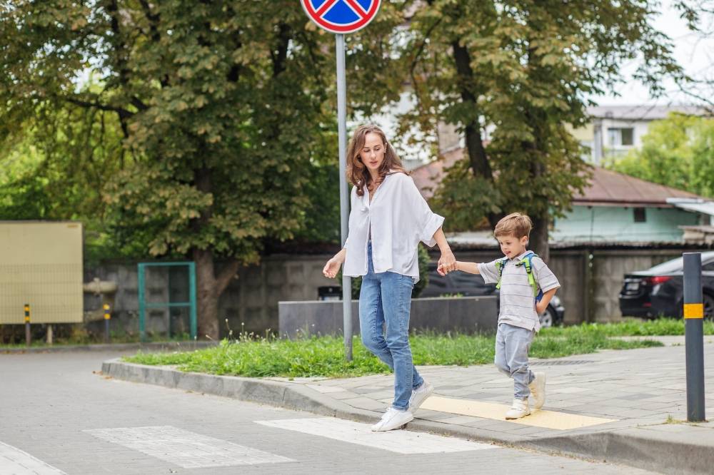 Mother and child crossing the pedestrian lane