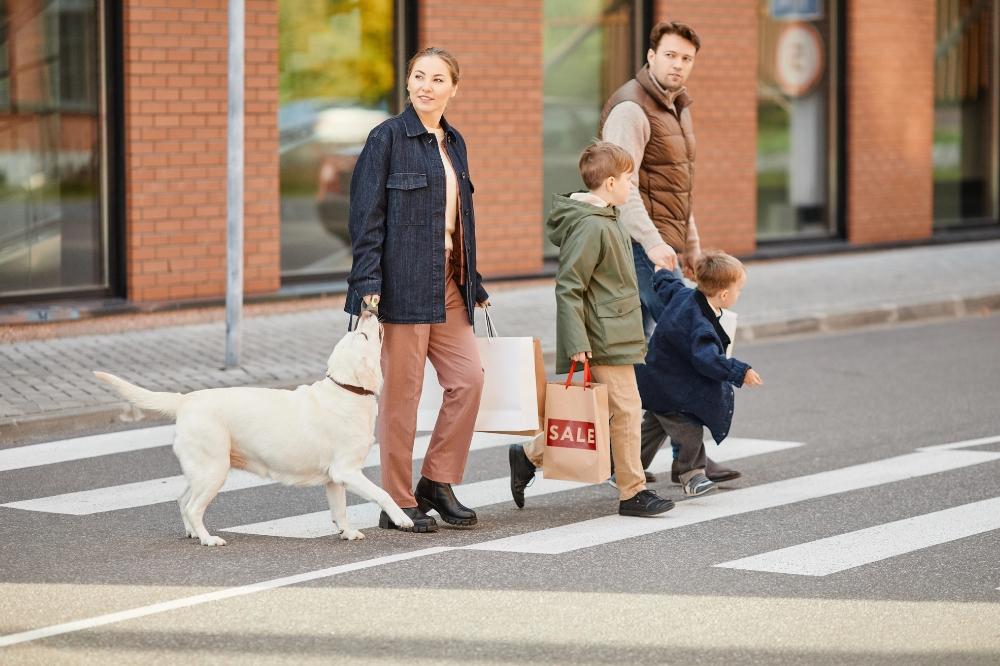 family with a dog crossing the pedestrian lane